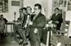 Σε καφενείο στο Καρλόβασι Σάμου το 1968. Διακρίνονται οι μουσικοί από αριστερά προς τα δεξιά: Χρήστος Βουρλιώτης (κιθάρα), Λημναίος (μπουζούκι), Πάρης (ακορντεόν), Κώστας Σεβαστάκης (σαξόφωνο). Πίσω: Ηλίας Διατσίδης (ντραμς).